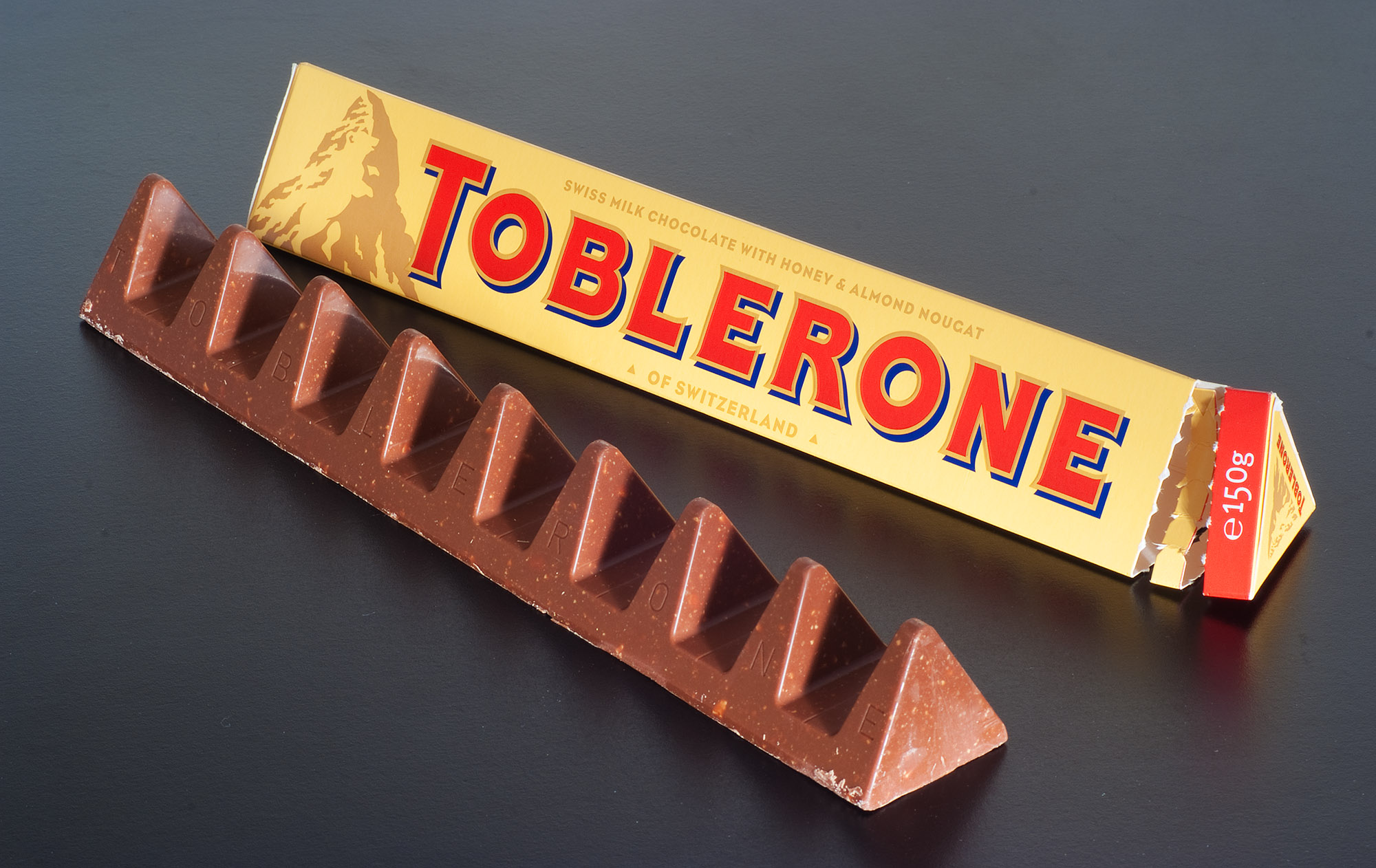 Shrinkflation — Toblerone bar from the United Kingdom with larger gaps between peaks, using 10% less chocolate.
